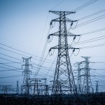 High voltage towers with sky background.