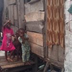 Children possing in front of one of the shanties in Otto