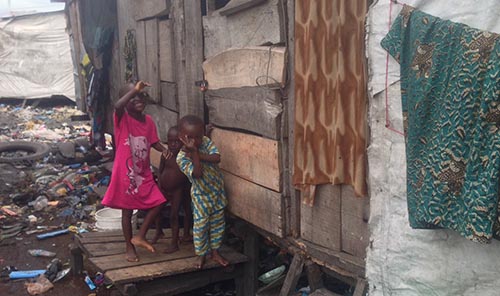 Children possing in front of one of the shanties in Otto