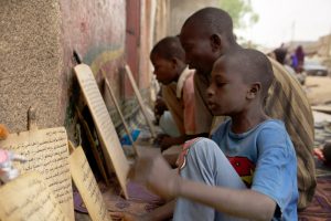 Almajiri Koran students outside Kano school recite Koran