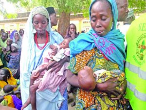 Women malnourished babies at an IDP camp in Borno