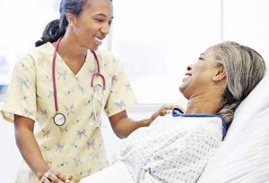 Nurse and patient talking in hospital