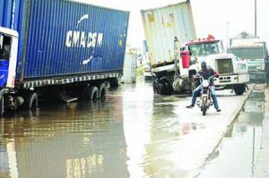 flooded-and-collapsed-road-opposite-tin-can-island-wharf