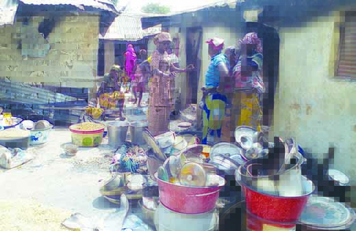 Women gathering their burnt properties,