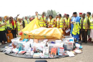 Deputy gov of Anambra State, Dr. Nkem Okeke unveiling the books, with Ihezie (5th left), his mum (4th left), Bloedorn (7th left) and others watching