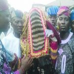 Olawayi Masquerade flanked by the custodian, Chief Sunday Olubodun and his son, Akeem