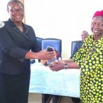 MD, Umuchinemere Micro Finance,22 Mrs Maria Nnenna Ekete presenting the first prize to her bank collected by the Chairman, Board Credit Committee, Chief Gilbert Obu