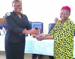 MD, Umuchinemere Micro Finance,22 Mrs Maria Nnenna Ekete presenting the first prize to her bank collected by the Chairman, Board Credit Committee, Chief Gilbert Obu