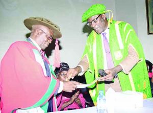 Prof. Oyesanya right, recieving the University’s Inauguaral lecture from Deputy VC Academic Prof James Ogbonna on the occasion