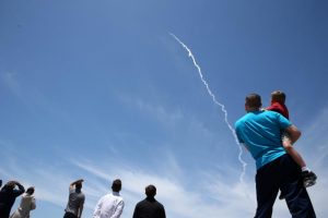 People watch as the Ground-based Midcourse Defense (GMD) element of the U.S. ballistic missile defense system launches during a flight test from Vandenberg Air Force Base