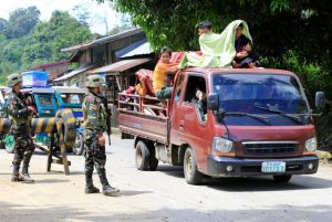 Government troops check a vehicle evacuating residents from their hometown of Marawi city in southern Philippines, as it drives past a military checkpoint in Pantar town, Lanao Del Norte