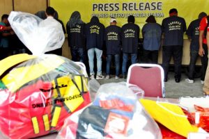Some of the more than 140 men detained after a raid on what authorities described as a gay prostitution ring being run out of an entertainment venue are shown to the media at a police station in Jakarta