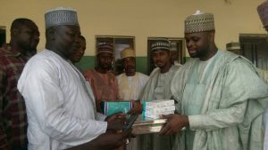 The President of Gombe Renaissance Initiative Mr. Salisu Abubakar Aliyu presenting drugs to Dr. Garba Audu Manasa Head of Clinical Services in the Gombe Specialist Hospital