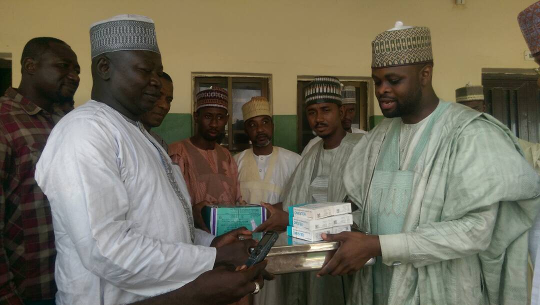 The President of Gombe Renaissance Initiative Mr. Salisu Abubakar Aliyu presenting drugs to Dr. Garba Audu Manasa Head of Clinical Services in the Gombe Specialist Hospital