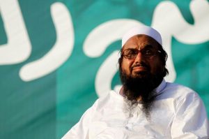 FILE PHOTO – Hafiz Muhammad Saeed, chief of the banned Islamic charity Jamat-ud-Dawa, looks over the crowed as they end a “Kashmir Caravan” from Lahore with a protest in Islamabad