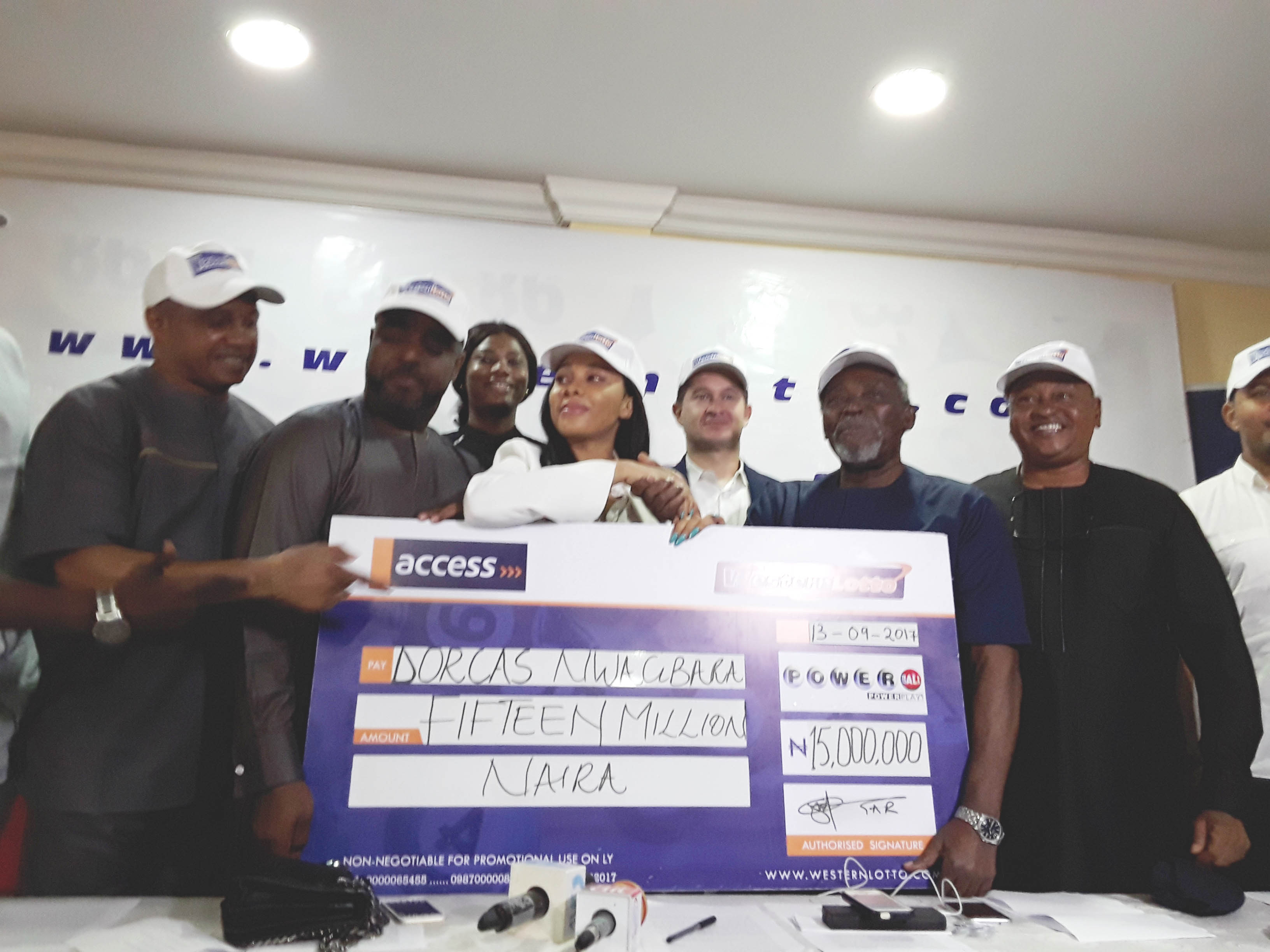 Lucky winner, Dorcas Nwagbara, surrounded by MD of Western Lotto, Mr. Yemi Ogunfowora and Nollywood actors, actress, comedians and muscian at the presentation ceremony in Lagos