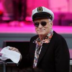 FILE PHOTO –  Hugh Hefner, founder of Playboy magazine, twirls a napkin during a performance by Dr. John and the Lower 911 at the 30th annual Playboy Jazz Festival at the Hollywood Bowl in Hollywood, California