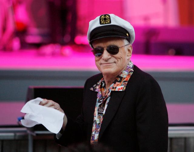 FILE PHOTO –  Hugh Hefner, founder of Playboy magazine, twirls a napkin during a performance by Dr. John and the Lower 911 at the 30th annual Playboy Jazz Festival at the Hollywood Bowl in Hollywood, California
