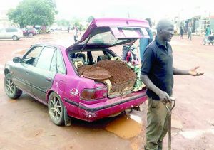 Daniel Davou repairing road at Jukwoyi
