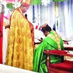 Bishop Nwokolo laying hands on Ven. Odita during the installation as Archdeacon of Omagba Archdeaconry