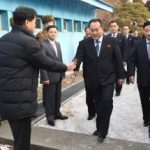 Head of North Korean delegation Ri Son Gwon, Chairman of the Committee for the Peaceful Reunification of the Country (CPRC) of DPRK, is greeted by a South Korean official as he crosses a concrete border to attend their meeting at the truce village of Panmu