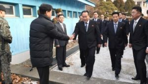 Head of North Korean delegation Ri Son Gwon, Chairman of the Committee for the Peaceful Reunification of the Country (CPRC) of DPRK, is greeted by a South Korean official as he crosses a concrete border to attend their meeting at the truce village of Panmu