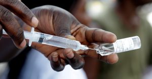 A Congolese health worker prepares to vaccinate a resident during an emergency campaign of vaccination against yellow fever in Kisenso district of the DRC’s capital Kinshasa