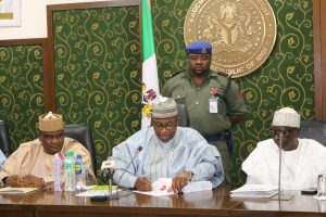 Governor Abubakar flanked by Speaker Kawuwa Damina (left) and the SSG Nadada Umar (right) siging the 2018 Appropriation Budget into law