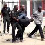 A man is arrested by the police for looting on the fourth day of a nationwide strike against the removal of the petrol subsidy in Lagos