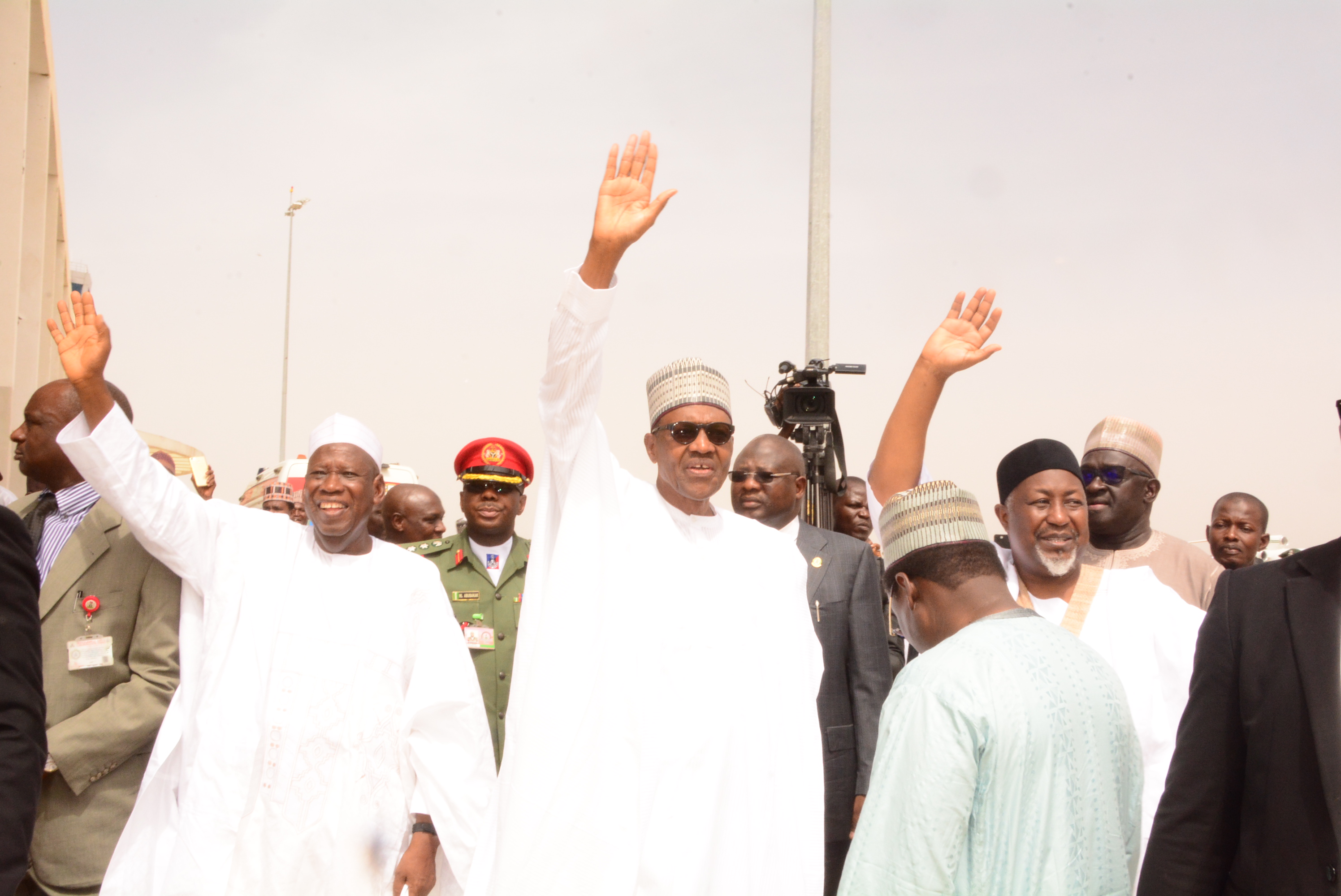 Pre Buhari flanked by Gov Badaru of Jigawa and his counterpart from Kano, Abdullahi Umar Ganduje weaving mamoth crowd at DIA, when the president visted the state, yeaterday. CUT CEE, GH DUTSE