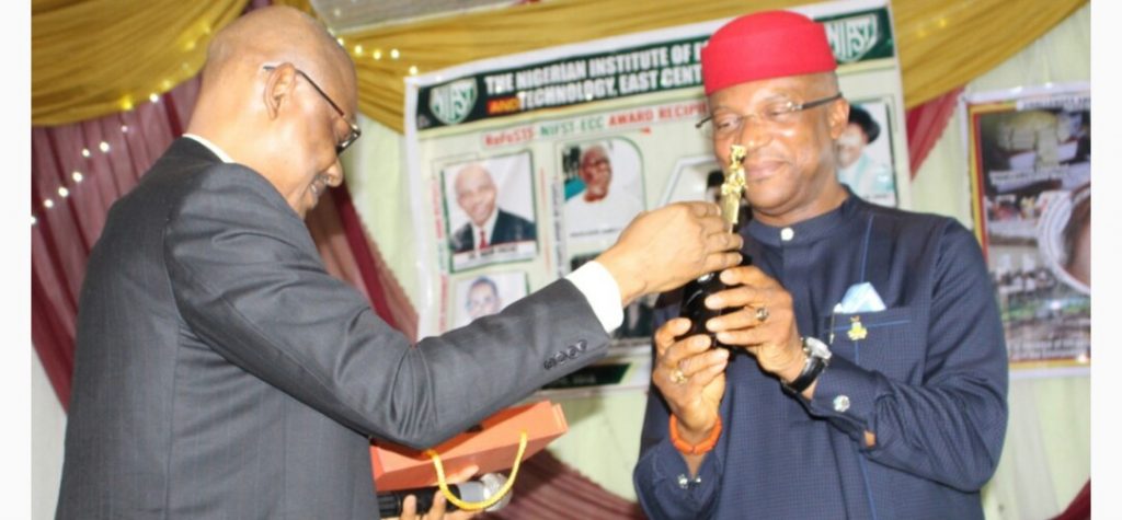 Anambra State Deputy Governor, Dr Nkem Okeke receiving the award as Most Amiable and Loyal Deputy Governor and a worthy friend of NIFST from Prof M. O. Iwe