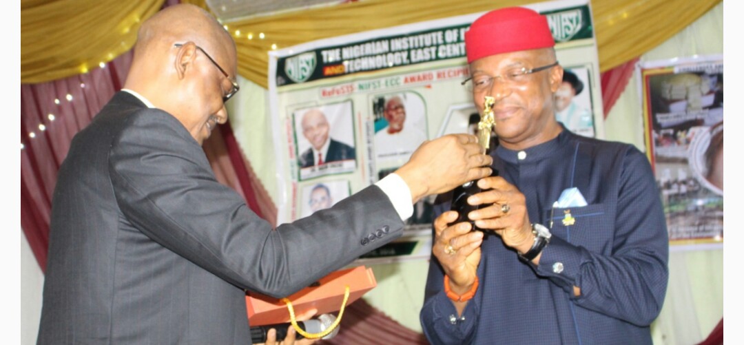 Anambra State Deputy Governor, Dr Nkem Okeke receiving the award as Most Amiable and Loyal Deputy Governor and a worthy friend of NIFST from Prof M. O. Iwe