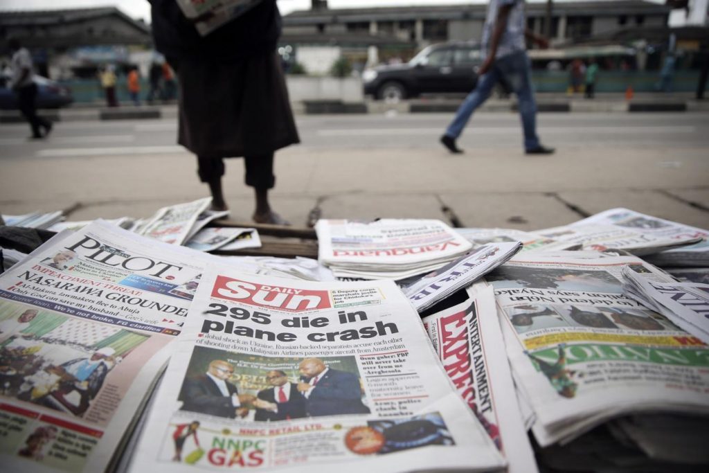 Newspapers are seen at a vendor’s stand along a road in Ikoyi district in Lagos