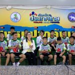 The 12 boys and their soccer coach who were rescued from a flooded cave arrive for a news conference in the northern province of Chiang Rai