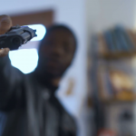 videoblocks-the-blurred-african-robber-aiming-with-the-gun-to-the-camera_bizivbpohg_thumbnail-full05