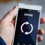 holding updating smartphone