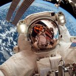 International Space Station and astronaut in outer space over th
