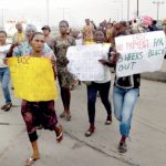 Women marching to the EKEDC office during the protest