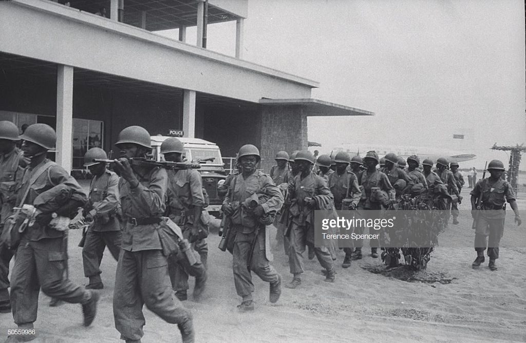 Congolese army troop marching down stree