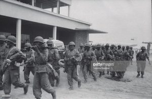 Congolese army troop marching down stree