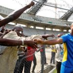 FILE PHOTO: Gabon’s striker Cousin meets construction workers before a training session at the Omnisport Stadium in Libreville