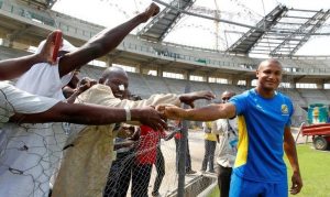 FILE PHOTO: Gabon’s striker Cousin meets construction workers before a training session at the Omnisport Stadium in Libreville
