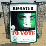 A poster reading ‘Register to vote’ is d