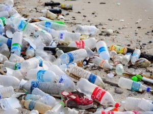 plastic-bottles-beach-rubbish-696×522