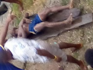 Okechukwu  lifeless body being carried out the river to the house
