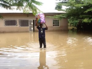 Man removing items from submerged house