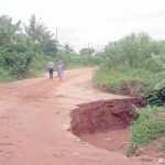 A road impacted by flood and erosion at Teboga