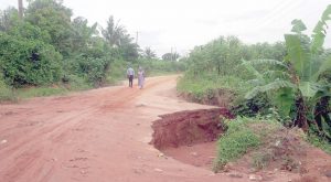 A road impacted by flood and erosion at Teboga