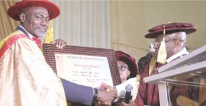 Ali (Left) receiving the certificate from the Founder of Oduduwa Uni- versity, Dr. Rahman Adedoyin after being conferred with the honor- ary doctorate degree at the institution