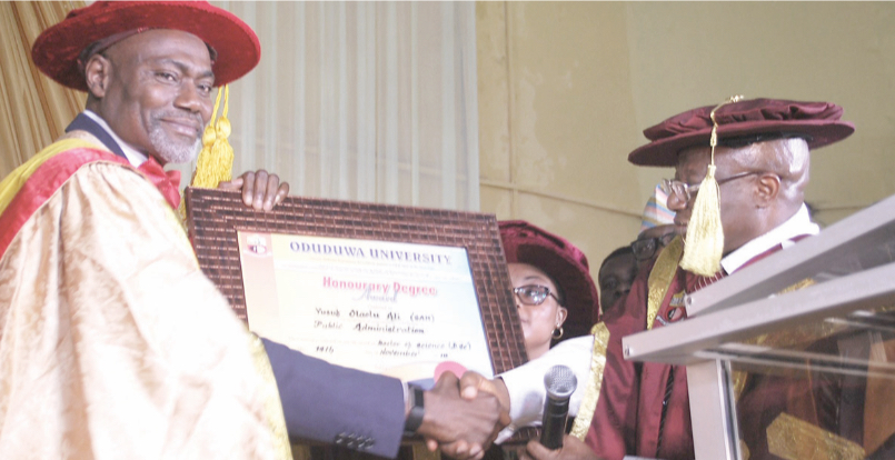 Ali (Left) receiving the certificate from the Founder of Oduduwa Uni- versity, Dr. Rahman Adedoyin after being conferred with the honor- ary doctorate degree at the institution